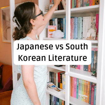 A woman with brown hair in a floral dress reaches for a book on a crowded white bookshelf. Large black text in a rounded white box centered over the image reads, "Japanese vs South Korean Literature."